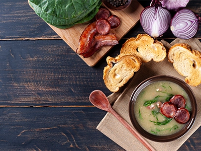 Popular dish of Portuguese cuisine called Caldo Verde. Made with potatoes, bacon, pepperoni sausage and kale.