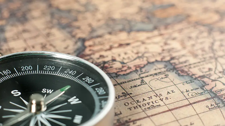 Compass on vintage map.